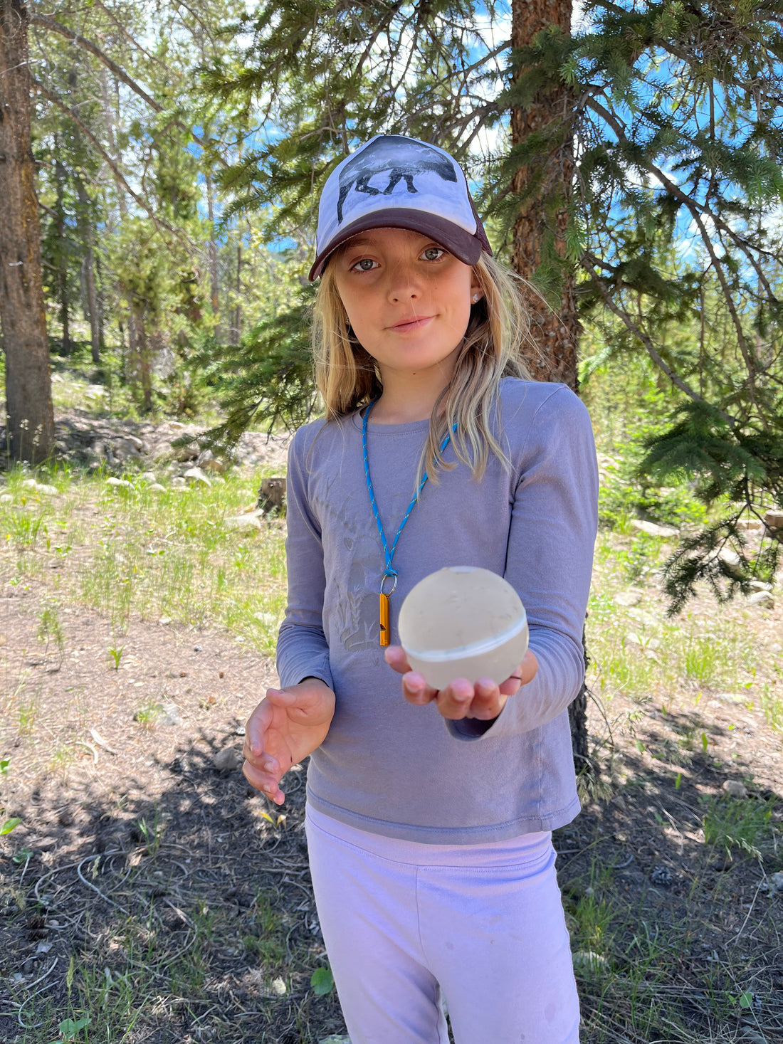 Camper holding a re-useable waterballoon for a camp activity in the Uinta Mountains.